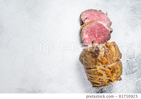 Roast beef meat fillet on kitchen table. White background. Top view. Copy space Roast beef meat fillet on kitchen table. White background. Top view. Copy space 81710923