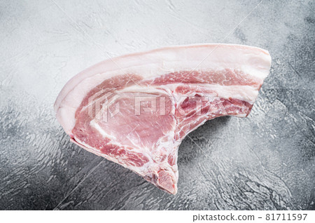 Raw whole rack of pork loin with ribs on kitchen table. White background. Top view 81711597