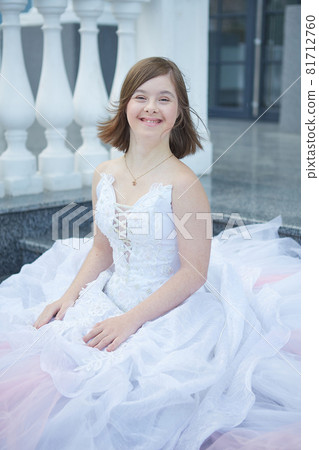 Girl with Down syndrome in  wedding dress. 81712760
