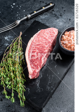 Wagyu raw sirloin steak, kobe beef meat on marble board. Black background. Top view Wagyu raw sirloin steak, kobe beef meat on marble board. Black background. Top view 81716320