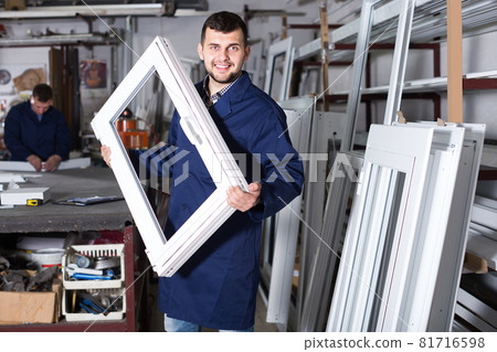 diligent male professional labours with finished PVC profiles and windows diligent male professional labours with finished PVC profiles and windows 81716598