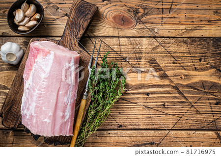 Raw pork loin with spices on wooden board. wooden background. Top view. Copy space Raw pork loin with spices on wooden board. wooden background. Top view. Copy space 81716975