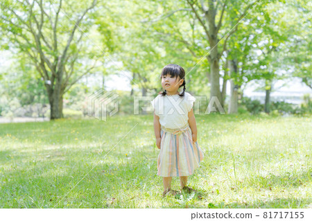 Photo of a girl standing in the woods Photo of a girl standing in the woods 81717155