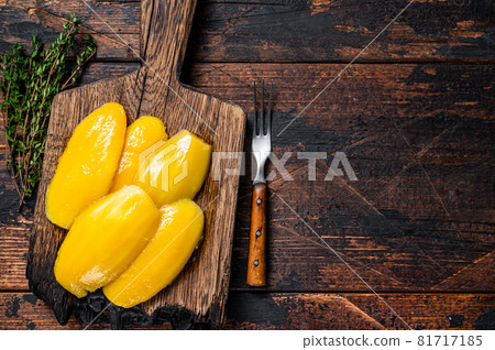 Preserve mango slices on a wooden board. Dark wooden background. Top view. Copy space Preserve mango slices on a wooden board. Dark wooden background. Top view. Copy space 81717185