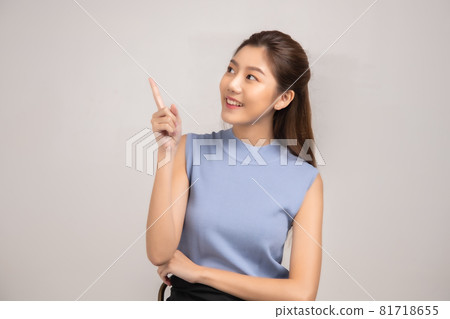 Thinking asian woman stand up  isolated on white background.Asian female model smiling looking up.woman pointing fingers away on white background  isolated. 81718655