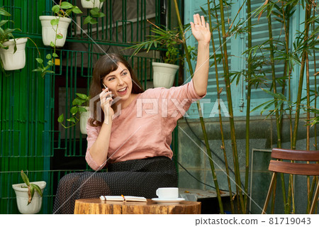 Joyful Woman Waving with Hand Joyful Woman Waving with Hand 81719043