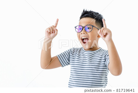Cutout portrait of pretty smart young healthy Asian boy wearing glasses and horizontal striped shirt happily raising hands and index fingers up with smile and shout out loud for signal sending 81719641