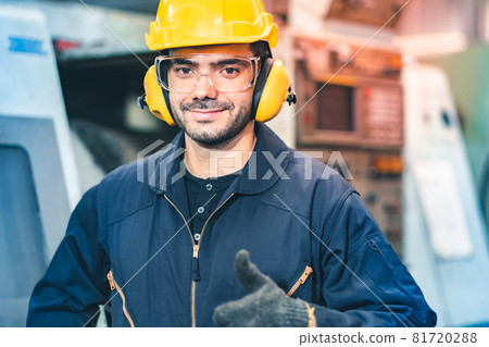 Industrial Engineers in Hard Hats.Work at the Heavy Industry Manufacturing Factory.industrial worker indoors in factory. man working in an industrial factory.Safety first concept. Industrial Engineers in Hard Hats.Work at the Heavy Industry Manufacturing Factory.industrial worker indoors in factory. man working in an industrial factory.Safety first concept. 81720288