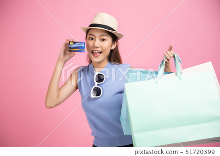 Asian pretty young woman sitting on pink pastel background. She smiling and happy shopping bags. she nice-looking lovely attractive shine She holding mobile. Asian pretty young woman sitting on pink pastel background. She smiling and happy shopping bags. she nice-looking lovely attractive shine She holding mobile. 81720399