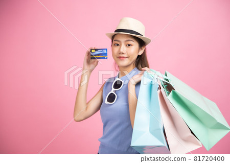 Asian pretty young woman sitting on pink pastel background. She smiling and happy shopping bags. she nice-looking lovely attractive shine She holding mobile. Asian pretty young woman sitting on pink pastel background. She smiling and happy shopping bags. she nice-looking lovely attractive shine She holding mobile. 81720400