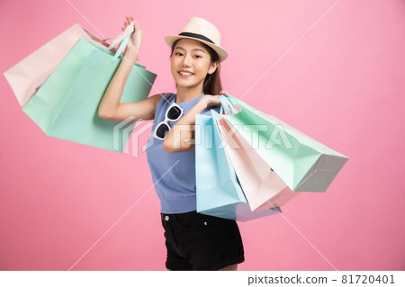Asian pretty young woman sitting on pink pastel background. She smiling and happy shopping bags. she nice-looking lovely attractive shine She holding mobile. Asian pretty young woman sitting on pink pastel background. She smiling and happy shopping bags. she nice-looking lovely attractive shine She holding mobile. 81720401