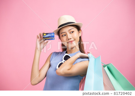 Asian pretty young woman sitting on pink pastel background. She smiling and happy shopping bags. she nice-looking lovely attractive shine She holding mobile. Asian pretty young woman sitting on pink pastel background. She smiling and happy shopping bags. she nice-looking lovely attractive shine She holding mobile. 81720402