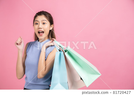 Asian pretty young woman sitting on pink pastel background. She smiling and happy shopping bags. she nice-looking lovely attractive shine She holding mobile. Asian pretty young woman sitting on pink pastel background. She smiling and happy shopping bags. she nice-looking lovely attractive shine She holding mobile. 81720427