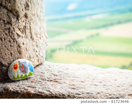 The picture painted on a stone is part of a children's tourist game. 81723646