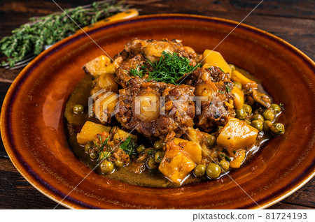 Beef veal oxtails stew with vegetables in a rustic plate. Dark wooden background. Top view Beef veal oxtails stew with vegetables in a rustic plate. Dark wooden background. Top view 81724193