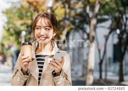 A woman wearing a trench coat and bra in the city A woman wearing a trench coat and bra in the city 81724885