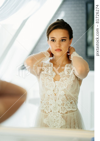 a beautiful young woman in a lace robe by the - Stock Photo [81726274] -  PIXTA