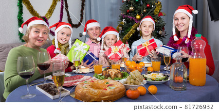 Portrait of family is sitting with New Year gifts Portrait of family is sitting with New Year gifts 81726932
