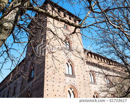 Travel to Italy - view of tower Castello Visconteo (Visconti Castle) through tree branches in Pavia city in spring 81728627
