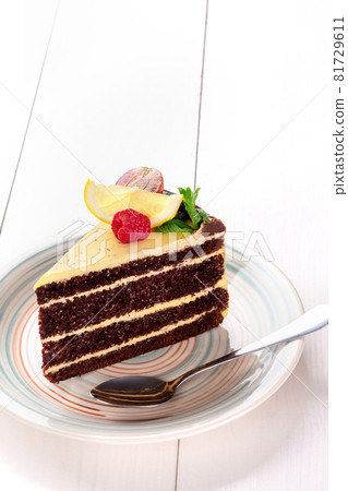 Small cake with different stuffing on a white plate. White wooden table. Small cake with different stuffing on a white plate. White wooden table. 81729611