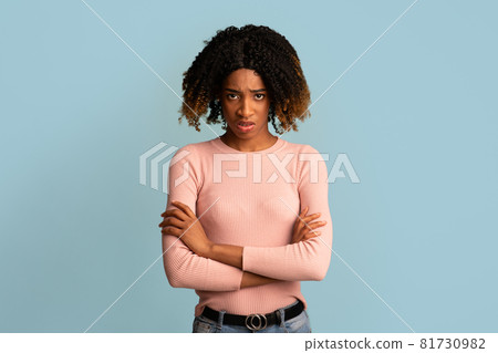 Portrait Of Offended Young African American Woman Standing With Folded Arms Portrait Of Offended Young African American Woman Standing With Folded Arms 81730982