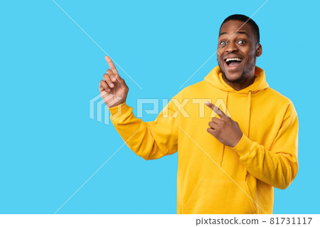 African Guy Pointing Fingers Aside Showing Blank Space, Blue Background 81731117