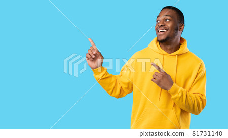 Cheerful African Man Pointing Fingers Aside On Blue Background, Panorama 81731140