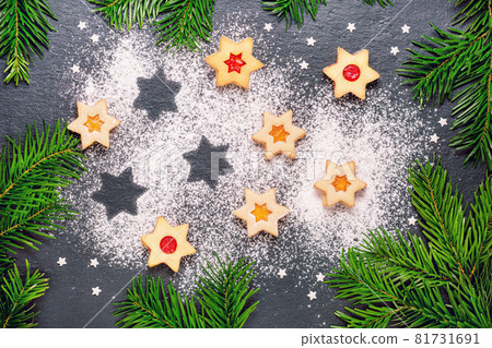 christmas linzer cookies with raspberry jam on slate table 81731691