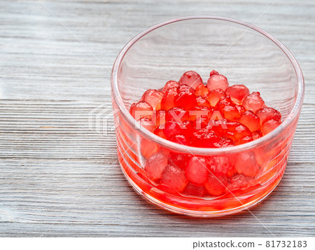 red colored boiled tapioca balls in glass bowl on gray wooden table red colored boiled tapioca balls in glass bowl on gray wooden table 81732183
