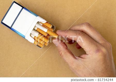 Smoker take a cigarette from the pack 81734244