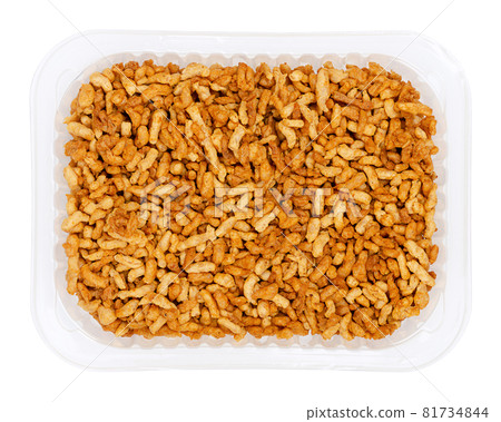 Vegan minced meat, in a clear plastic tray. Substitute and alternative for ground meat, based on seasoned pea protein, passed through a spiral screw mincer. Close-up from above over white, food photo. Vegan minced meat, in a clear plastic tray. Substitute and alternative for ground meat, based on seasoned pea protein, passed through a spiral screw mincer. Close-up from above over white, food photo. 81734844