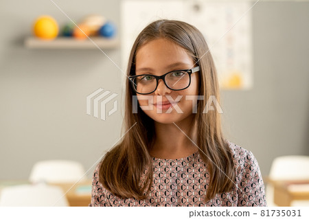 Cute secondary school pupil in eyeglasses looking at camera 81735031