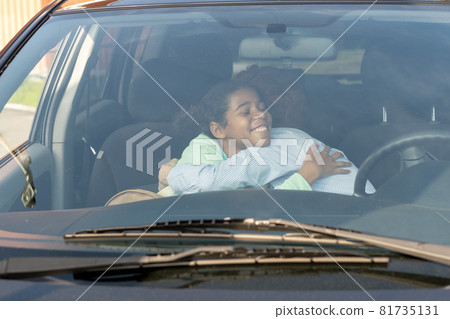 Mom and daughter giving each other goodbye hug before going to school Mom and daughter giving each other goodbye hug before going to school 81735131