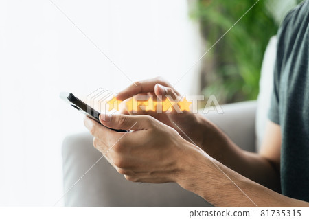 Close up of man customer giving a five star rating on smartphone. Review, Service rating, satisfaction, Customer service experience and satisfaction survey concept. Close up of man customer giving a five star rating on smartphone. Review, Service rating, satisfaction, Customer service experience and satisfaction survey concept. 81735315