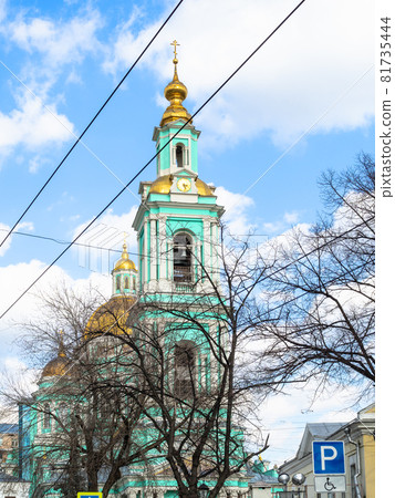 view of bell tower of Cathedral of the Epiphany in Yelokhovo in Moscow public garden at Spartakovskaya Street in sunny spring day view of bell tower of Cathedral of the Epiphany in Yelokhovo in Moscow public garden at Spartakovskaya Street in sunny spring day 81735444