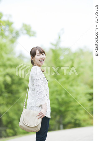 A woman stretching in the fresh greenery 81735518