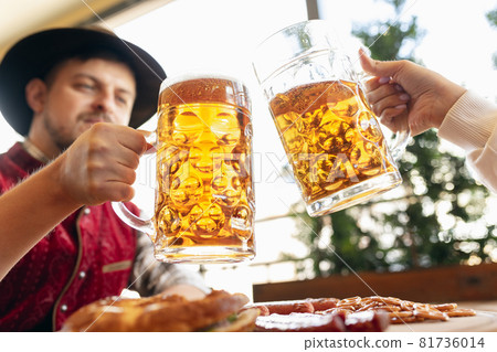 Group of friends meeting at bar, cafe and drinking beer at beer festival. Traditions, fun, joy, friendship, holidays. Oktoberfest, october, autumn concept 81736014