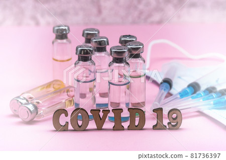 Medical ampoules and mask. Syringes and ampoules. Pink background. Injections and medications. Medical ampoules and mask. Syringes and ampoules. Pink background. Injections and medications. 81736397