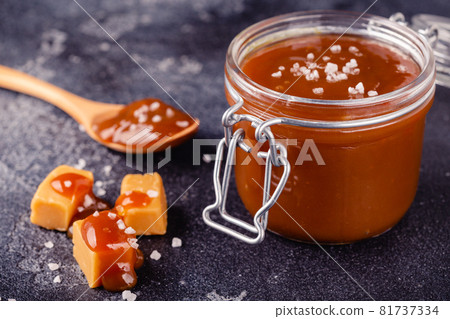 Glass jar with tasty delicious salted caramel Glass jar with tasty delicious salted caramel 81737334