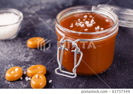 Glass jar with tasty delicious salted caramel 81737349