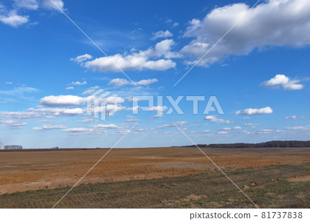 Beautiful cloudy sky over farmland. Spring landscape. Beautiful cloudy sky over farmland. Spring landscape. 81737838