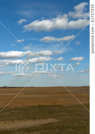 Beautiful cloudy sky over farmland. Spring landscape. Beautiful cloudy sky over farmland. Spring landscape. 81737839