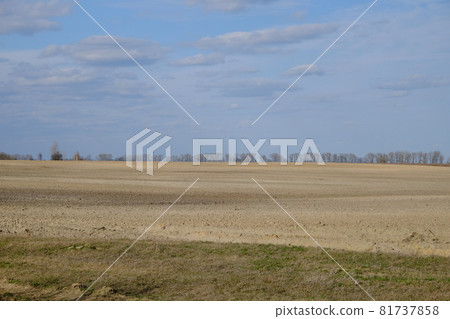Beautiful cloudy sky over farmland. Spring landscape. 81737858