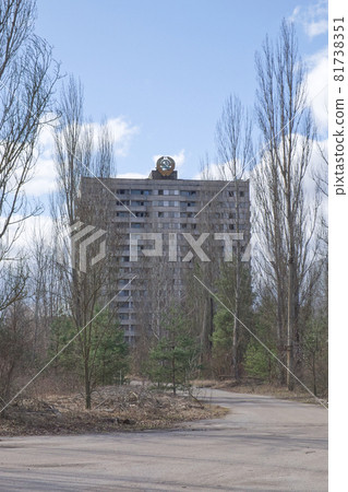Abandoned high house in the ghost town of Pripyat. An abandoned city overgrown with trees. The area is contaminated with radiation. Coat of arms of the Soviet republic on the roof of the building. Abandoned high house in the ghost town of Pripyat. An abandoned city overgrown with trees. The area is contaminated with radiation. Coat of arms of the Soviet republic on the roof of the building. 81738351
