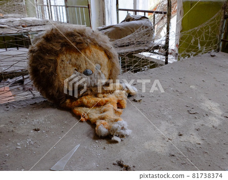 An old torn plush toy in an abandoned kindergarten. An abandoned kindergarten in Chernobyl. 81738374