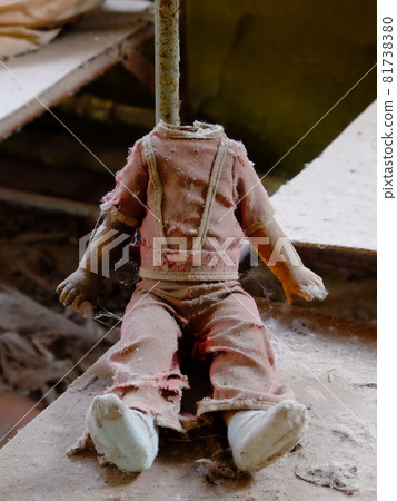 Children's doll without a head. A dirty, broken children's toy from a radiation-contaminated kindergarten in Chernobyl. Children's doll without a head. A dirty, broken children's toy from a radiation-contaminated kindergarten in Chernobyl. 81738380