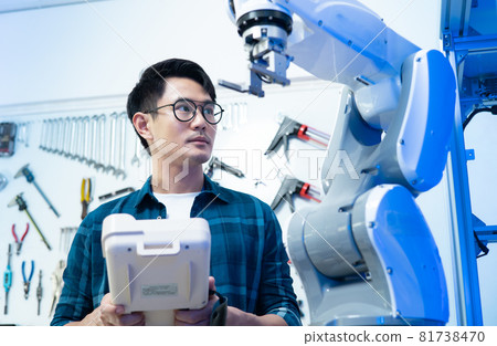 Male Engineers Maintenance Robot Arm at Lab. he are in a High Tech Research Laboratory with Modern Equipment.Professional Japanese Development Engineer is Testing an Artificial Intelligence.start up . 81738470