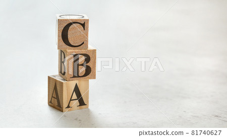 Pile with three wooden cubes - letters CBA meaning Cost Benefit Assessment on them, space for more text / images at right side. Pile with three wooden cubes - letters CBA meaning Cost Benefit Assessment on them, space for more text / images at right side. 81740627