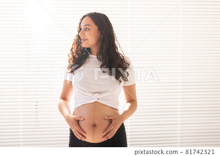 Pregnant woman touching her belly, copy space. Pregnancy and maternity leave 81742321
