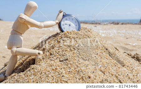 A drawing doll trying to stop a pocket watch on the crumbling sand A drawing doll trying to stop a pocket watch on the crumbling sand 81743446